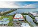 Overhead view of condo community with manicured lawns, swimming pool, boat docks, and waterfront access at 3805 E Bay Dr # 301, Holmes Beach, FL 34217