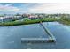 Scenic view of the condos waterfront property with a long wooden pier at 3805 E Bay Dr # 301, Holmes Beach, FL 34217