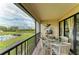 Screened lanai with comfortable seating and views of the pool, golf course, and surrounding landscaping at 3805 E Bay Dr # 301, Holmes Beach, FL 34217