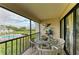 Relaxing screened-in balcony featuring outdoor seating and views of the pool and manicured landscaping at 3805 E Bay Dr # 301, Holmes Beach, FL 34217