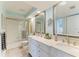Well lit bath includes double sinks, large mirror, and neutral walls at 3805 E Bay Dr # 301, Holmes Beach, FL 34217