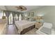 Bedroom with ceiling fan, neutral walls, and access to the outdoor patio at 3805 E Bay Dr # 301, Holmes Beach, FL 34217