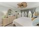Well lit bedroom features stylish furniture and a serene view from the window at 3805 E Bay Dr # 301, Holmes Beach, FL 34217