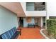 Inviting common area with benches, and a decorative sun on the wall at 3805 E Bay Dr # 301, Holmes Beach, FL 34217