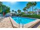 Enjoy the sunshine at the community pool featuring lounge chairs and shade umbrellas at 3805 E Bay Dr # 301, Holmes Beach, FL 34217