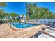 Relax by the sparkling community pool with comfortable lounge chairs and lush landscaping at 3805 E Bay Dr # 301, Holmes Beach, FL 34217