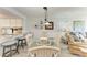 Cozy dining area adjacent to the kitchen and living room with coastal decor at 3805 E Bay Dr # 301, Holmes Beach, FL 34217