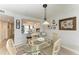 Charming dining space featuring a glass table and wicker chairs at 3805 E Bay Dr # 301, Holmes Beach, FL 34217