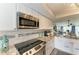 Updated kitchen featuring granite countertops, stainless appliances, and views of the living area at 3805 E Bay Dr # 301, Holmes Beach, FL 34217