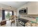 This eat-in kitchen has stainless steel appliances and a pleasant view of the outside patio at 3805 E Bay Dr # 301, Holmes Beach, FL 34217