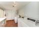 Community laundry room features modern machines, folding table, and sink for residents at 3805 E Bay Dr # 301, Holmes Beach, FL 34217