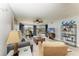 Inviting living room featuring a plush sofa, rattan accents, modern ceiling fan, and sliding glass doors to the lanai at 3805 E Bay Dr # 301, Holmes Beach, FL 34217