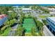 Aerial view of well-maintained tennis courts within a lush, landscaped community at 3805 E Bay Dr # 301, Holmes Beach, FL 34217