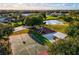 Overhead view of community amenities including a basketball court, playground, pond, and picnic shelter at 3902 162Nd E Ave, Parrish, FL 34219
