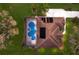 Aerial view of a house featuring a pool, solar panels, and well-maintained lawn and landscaping at 3902 162Nd E Ave, Parrish, FL 34219