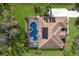 Aerial view of a home featuring a screened pool, solar panels, and a well-maintained lawn in a quiet neighborhood setting at 3902 162Nd E Ave, Parrish, FL 34219