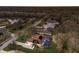 A nighttime aerial view of a home with a pool and large backyard with mature trees at 3902 162Nd E Ave, Parrish, FL 34219