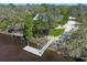 Waterfront home featuring a private dock on a calm river surrounded by lush greenery at 3902 162Nd E Ave, Parrish, FL 34219