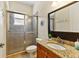 Nicely appointed bathroom features a glass enclosed shower, wood vanity and granite countertops at 3902 162Nd E Ave, Parrish, FL 34219