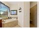 Bathroom with soaking tub featuring tile surround and a separate tiled walk-in shower at 3902 162Nd E Ave, Parrish, FL 34219