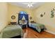 Bright bedroom with two beds, a window and a ceiling fan at 3902 162Nd E Ave, Parrish, FL 34219