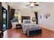Warm bedroom featuring hardwood floors, a dark wood headboard, and matching dark wood side tables at 3902 162Nd E Ave, Parrish, FL 34219