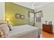 Comfortable bedroom featuring wood floors, ceiling fan, and a three-drawer dresser at 3902 162Nd E Ave, Parrish, FL 34219