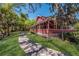 Quaint two-story home with a welcoming porch and lush landscaping bordering the riverfront at 3902 162Nd E Ave, Parrish, FL 34219