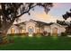 Stunning single-story home with lush landscaping, manicured lawn, and beautiful architectural details at 3902 162Nd E Ave, Parrish, FL 34219