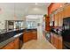 Bright kitchen featuring wooden cabinets, granite countertops, tile flooring, and modern appliances at 3902 162Nd E Ave, Parrish, FL 34219