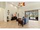 Cozy living room with neutral walls, a ceiling fan, and sliding glass doors leading to the outdoor patio at 3902 162Nd E Ave, Parrish, FL 34219