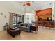Open-concept living space with pool views, a cozy sofa, and breakfast bar at 3902 162Nd E Ave, Parrish, FL 34219