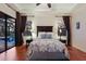 Bright main bedroom boasts wood floors, tray ceiling, and decorative headboard at 3902 162Nd E Ave, Parrish, FL 34219