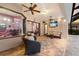 A covered patio with two ceiling fans, furniture, and a view into the interior of the home at 3902 162Nd E Ave, Parrish, FL 34219