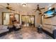 A covered patio with ceiling fans, furniture, and a view into the interior of the home at 3902 162Nd E Ave, Parrish, FL 34219