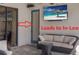 Relaxing covered patio features comfortable seating, ceiling fan, and a mounted television for outdoor entertainment at 3902 162Nd E Ave, Parrish, FL 34219