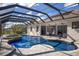 The backyard features a screened-in pool with a spacious patio, perfect for outdoor gatherings and enjoying the sunny weather at 3902 162Nd E Ave, Parrish, FL 34219