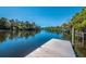 Scenic river view with a private dock extending into the calm, tree-lined waterway at 3902 162Nd E Ave, Parrish, FL 34219
