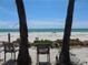 Scenic beach view framed by palm trees, perfect for relaxation and enjoying the ocean breeze at 4460 Ironwood Cir # 505Ad, Bradenton, FL 34209
