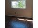 The bedroom has sleek dark floors, fresh paint, and a window offering natural light at 4460 Ironwood Cir # 505Ad, Bradenton, FL 34209