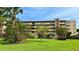 Exterior view of building with well maintained lawn, greenery and unit parking at 4460 Ironwood Cir # 505Ad, Bradenton, FL 34209