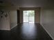 The living room features sleek dark floors, fresh paint, and access to a private outdoor patio at 4460 Ironwood Cir # 505Ad, Bradenton, FL 34209
