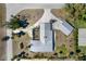 Bird's eye view showcasing property layout with lush landscaping, metal roofs, and a spacious driveway at 45 Cape Haze Dr, Placida, FL 33946