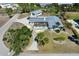 Aerial view of updated single-Gathering home with mature landscaping and circular driveway at 45 Cape Haze Dr, Placida, FL 33946