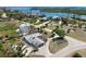 An aerial view of a beautiful home featuring a screened in patio, extra garage, and circular driveway at 45 Cape Haze Dr, Placida, FL 33946