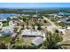 Aerial view of waterfront neighborhood with lush landscaping, backyard, and a driveway at 45 Cape Haze Dr, Placida, FL 33946