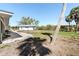 A spacious backyard with palm trees, green grass, and a view of neighboring homes at 45 Cape Haze Dr, Placida, FL 33946