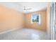 Cozy bedroom with light peach walls, a ceiling fan, and natural light through the window at 45 Cape Haze Dr, Placida, FL 33946