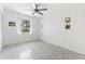 Minimal bedroom featuring a window, ceiling fan and white walls at 45 Cape Haze Dr, Placida, FL 33946