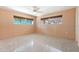 Clean bedroom featuring two windows with blinds, neutral walls and concrete flooring at 45 Cape Haze Dr, Placida, FL 33946